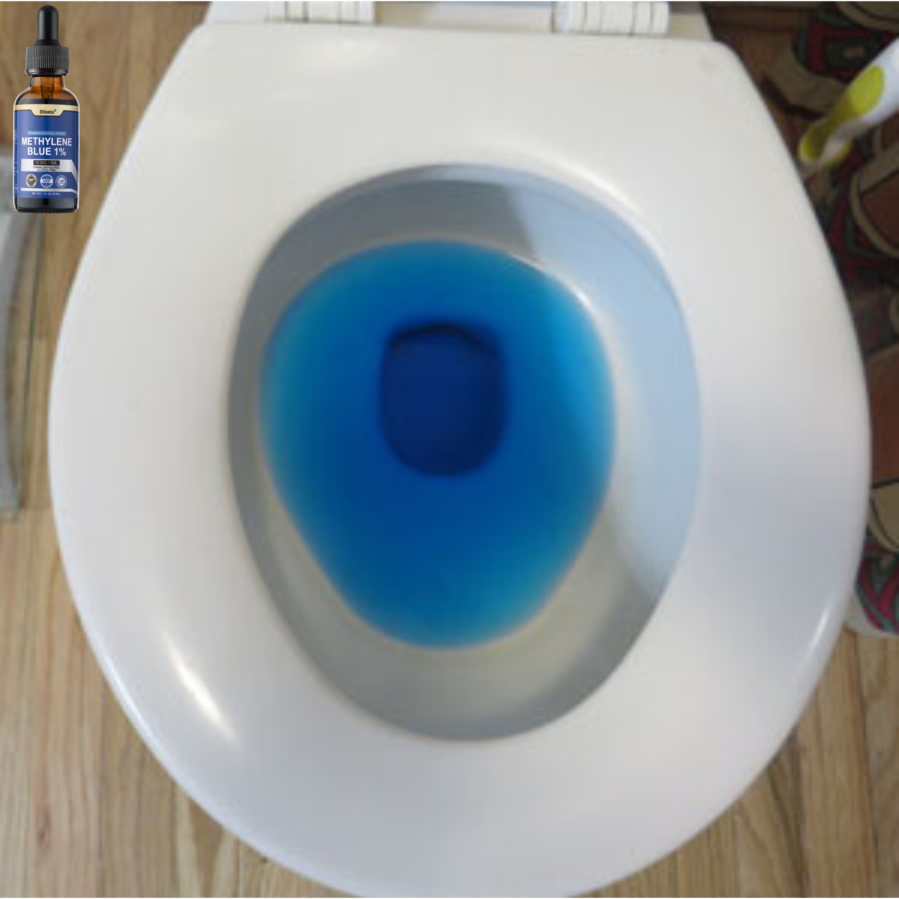 Toilet bowl with blue liquid and a bottle of methylene blue.