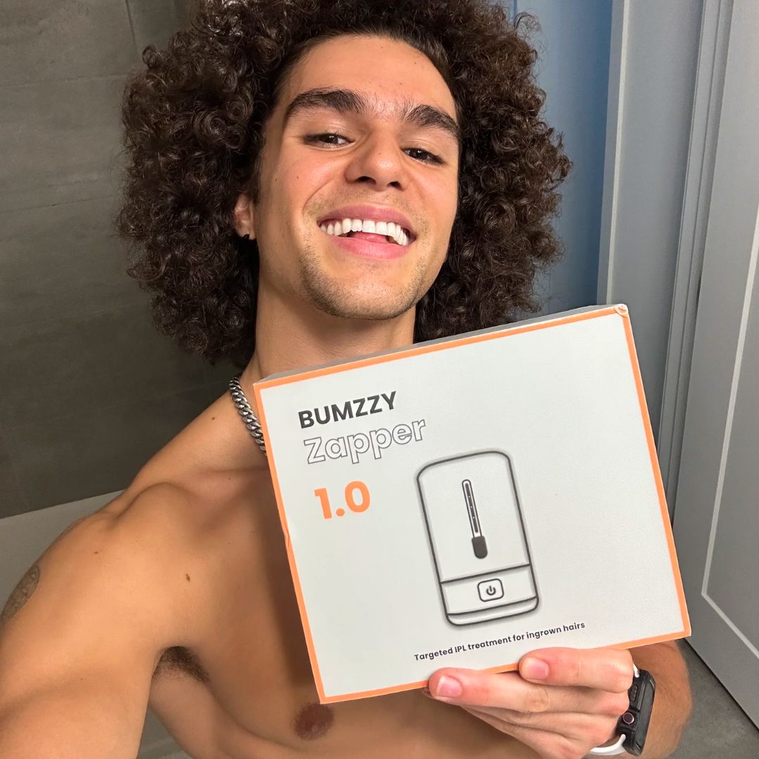 Person smiling and holding a box with 'Bumzzy Zapper 1.0' text.
