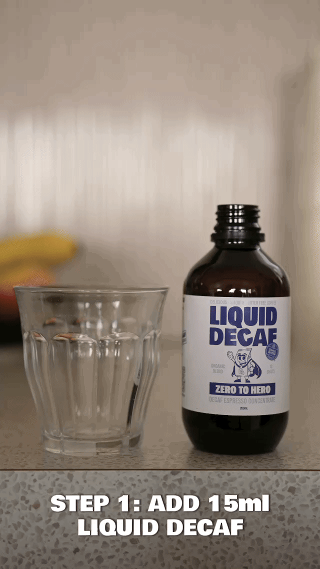 Glass and bottle of Liquid Decaf on a countertop with text instructions.