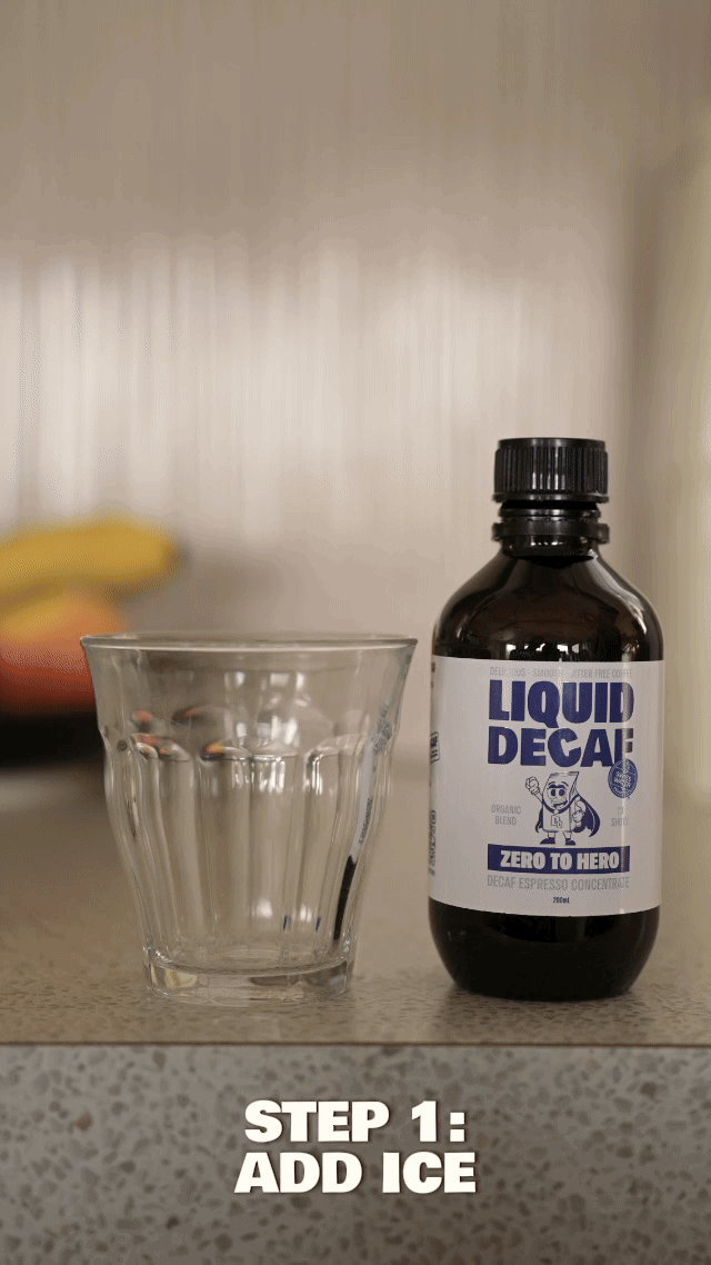 Glass and bottle labeled 'Liquid Decaf' on a counter with text 'Step 1: Add Ice.'