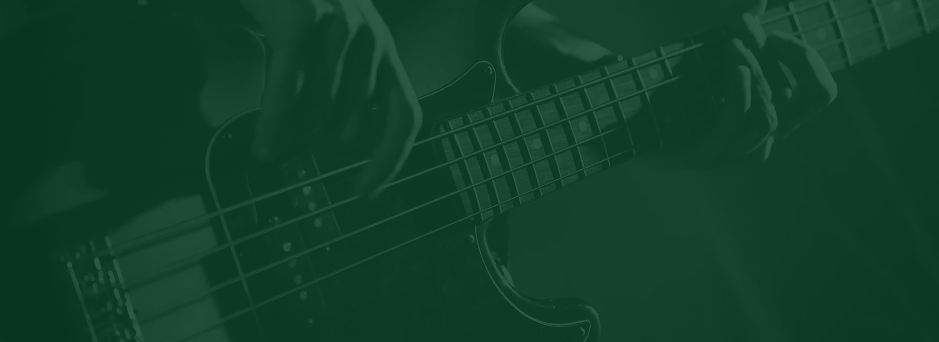 Close-up of a person playing a bass guitar.