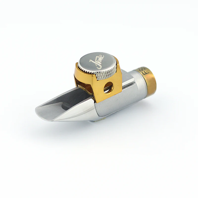 Silver and gold saxophone mouthpiece on a white background.