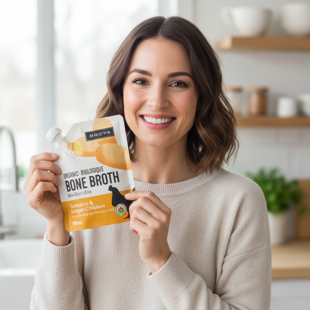 Person smiling, holding a Broya organic bone broth package.