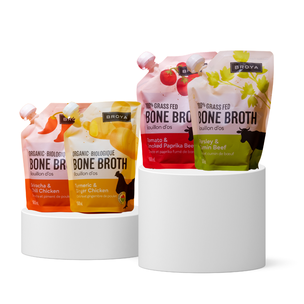 Four pouches of Broya bone broth on white cylindrical stands.