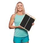 Woman holding a wooden slant board.