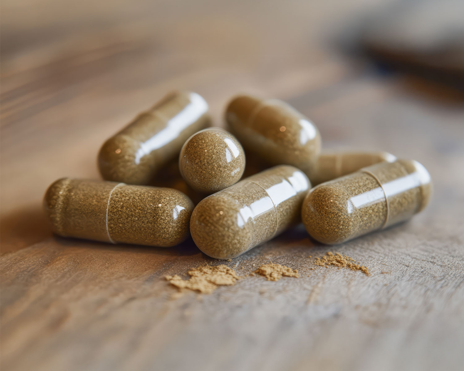 Close-up of brown capsules on a wooden surface.