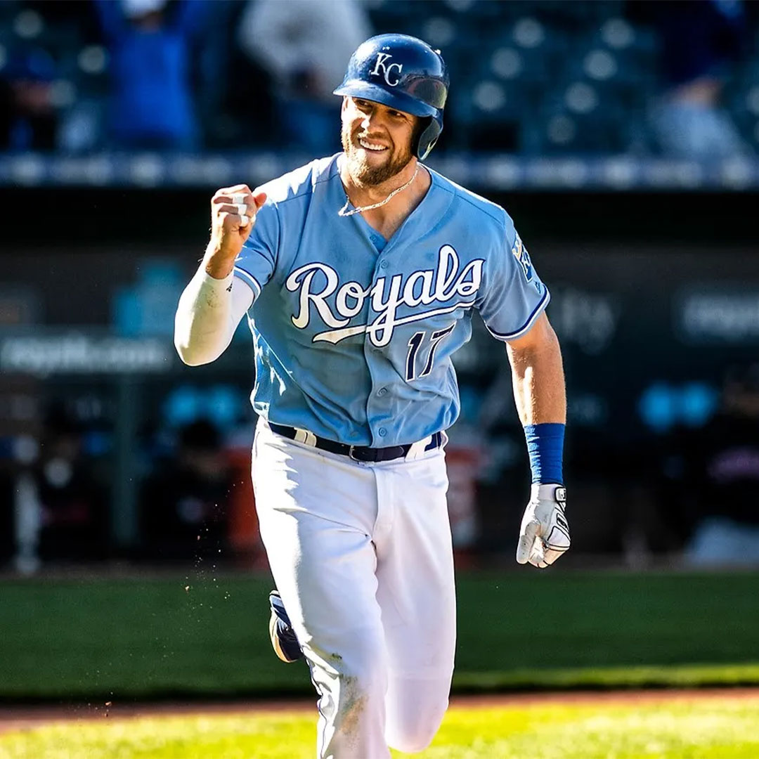 Baseball player in Royals uniform celebrating on the field.