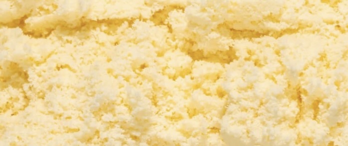 A close-up, textural shot of pale yellow ice cream.