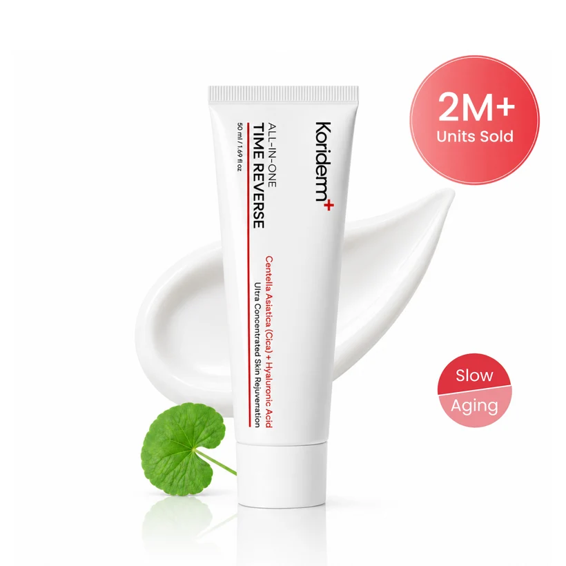A white tube of Koriderm+ Time Reverse cream with a swirl of product and a green leaf.