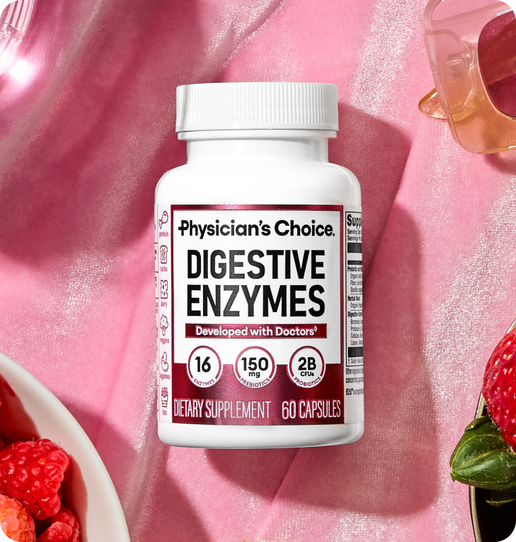 A bottle of Physician's Choice Digestive Enzymes on a pink satin background with berries and sunglasses.