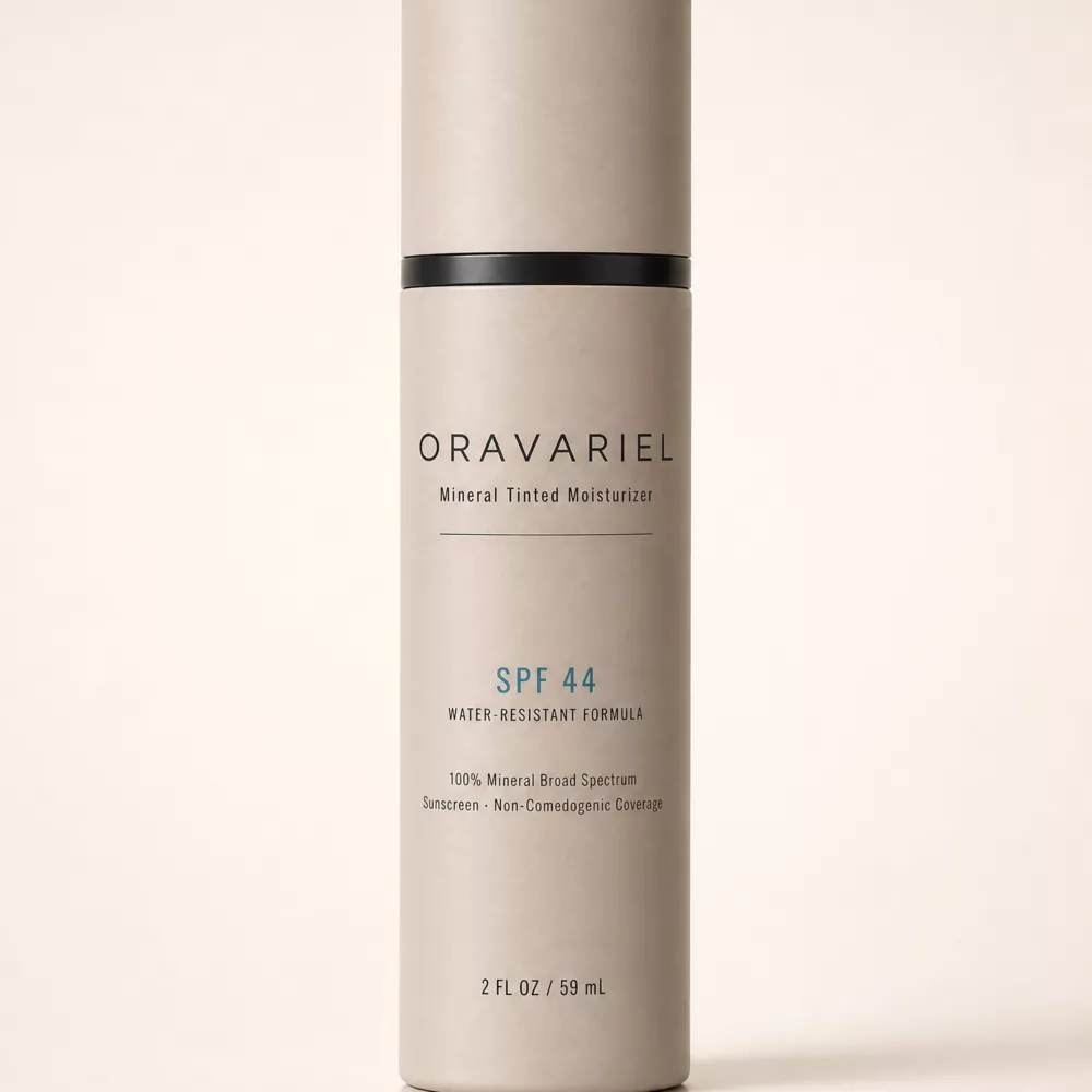 A bottle of Oravariel Mineral Tinted Moisturizer SPF 44 against a plain, light-colored background.