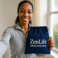 Person holding a blue bag with 'ZenLife Grounding' text.