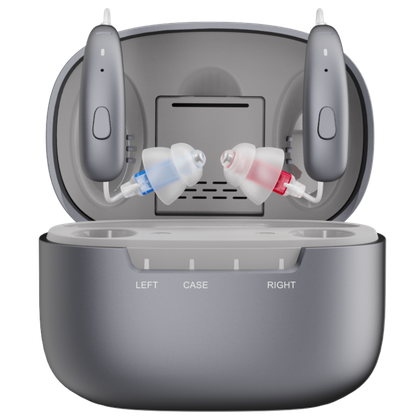 A pair of grey, modern hearing aids with red and blue earpieces in an open charging case.