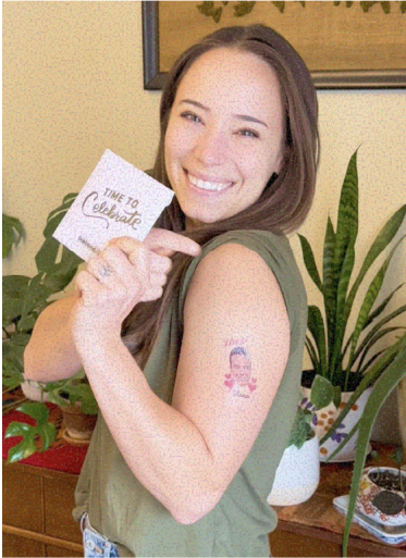 Smiling woman showing a temporary tattoo and holding a 'Time to Celebrate' card.