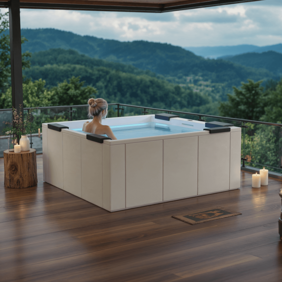 Person relaxing in a hot tub on a wooden deck with mountain view.
