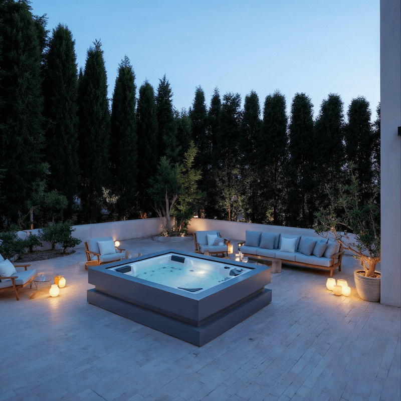 Outdoor patio with a hot tub, seating, and ambient lighting at dusk.