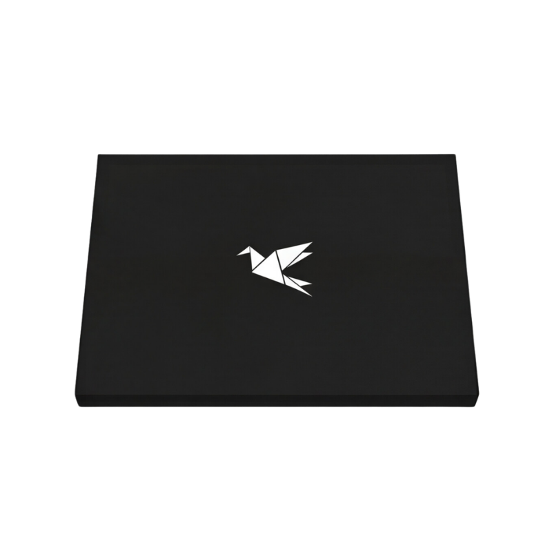 A closed black laptop with a white origami bird logo on the lid, against a white background.