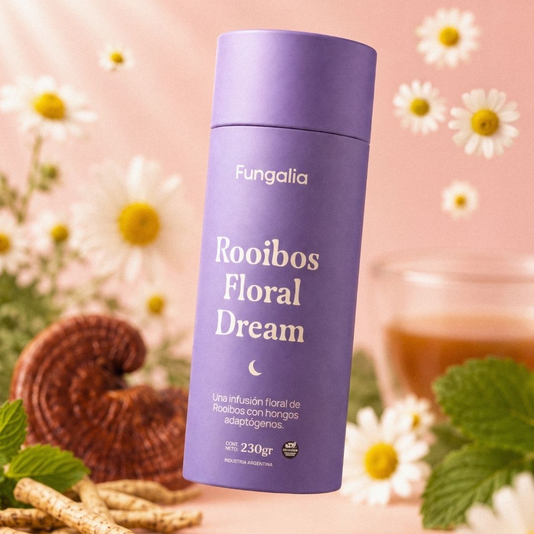 A purple container of Fungalia Rooibos Floral Dream tea surrounded by chamomile, mushrooms, mint, and roots.