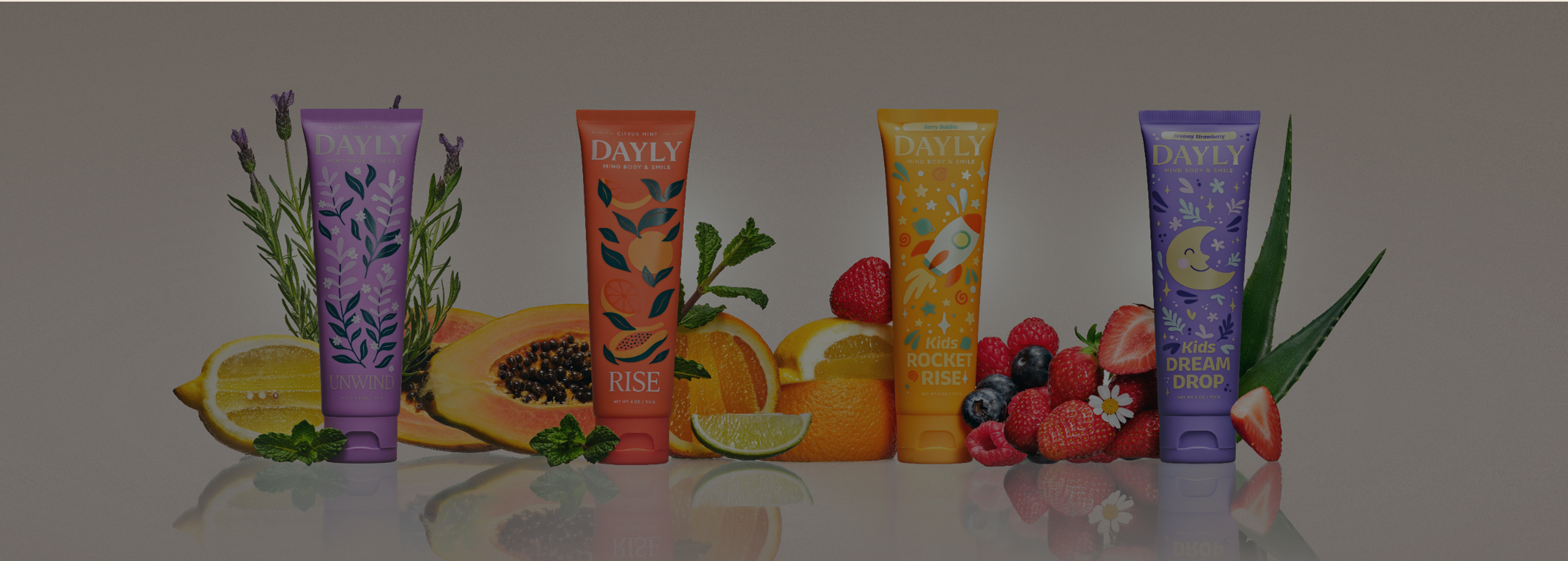 Two tubes of Dayly brand products, Rise and Kids Rocket Rise, surrounded by fresh fruits and mint.