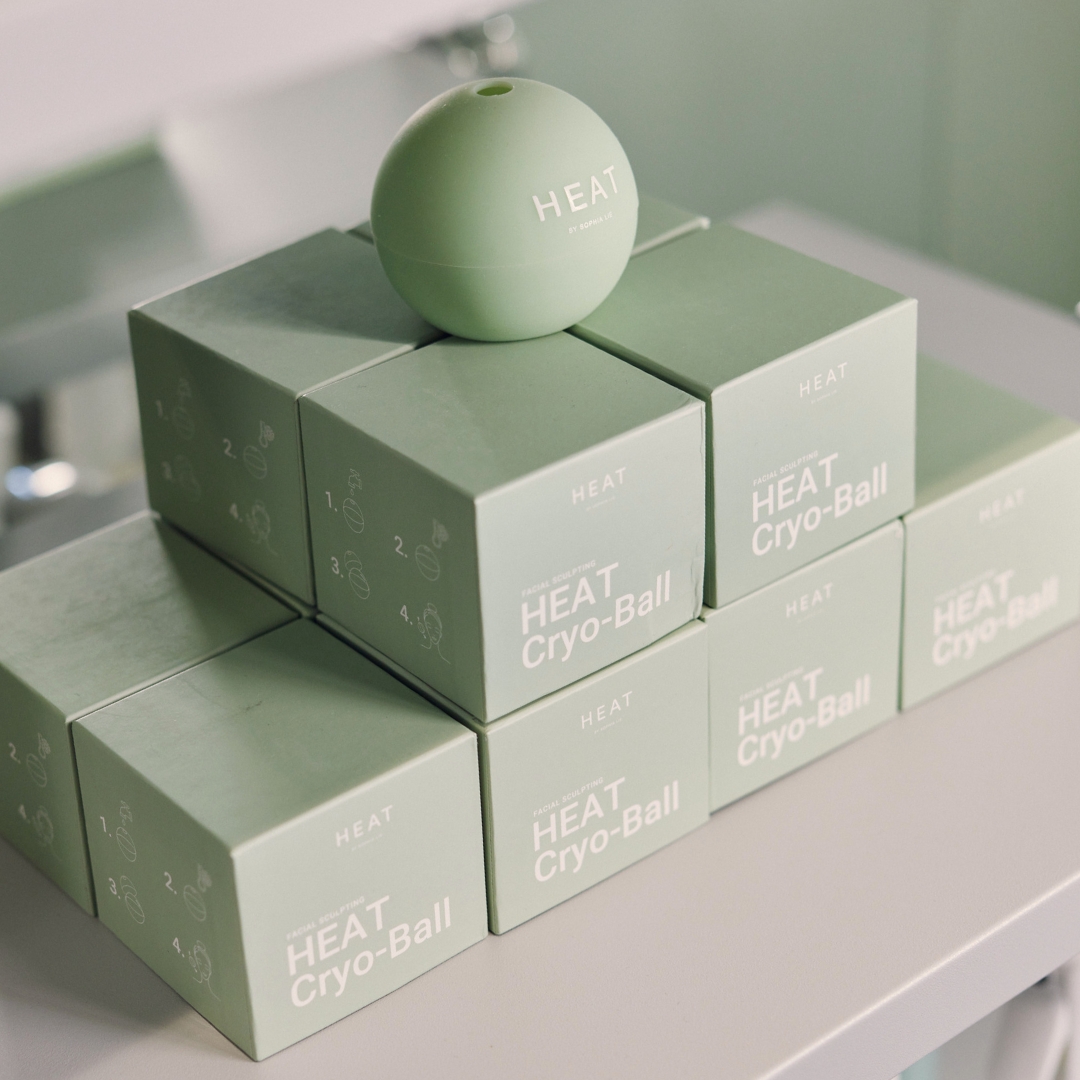 Green ball on stacked boxes labeled 'HEAT Cryo-Ball' on a shelf.