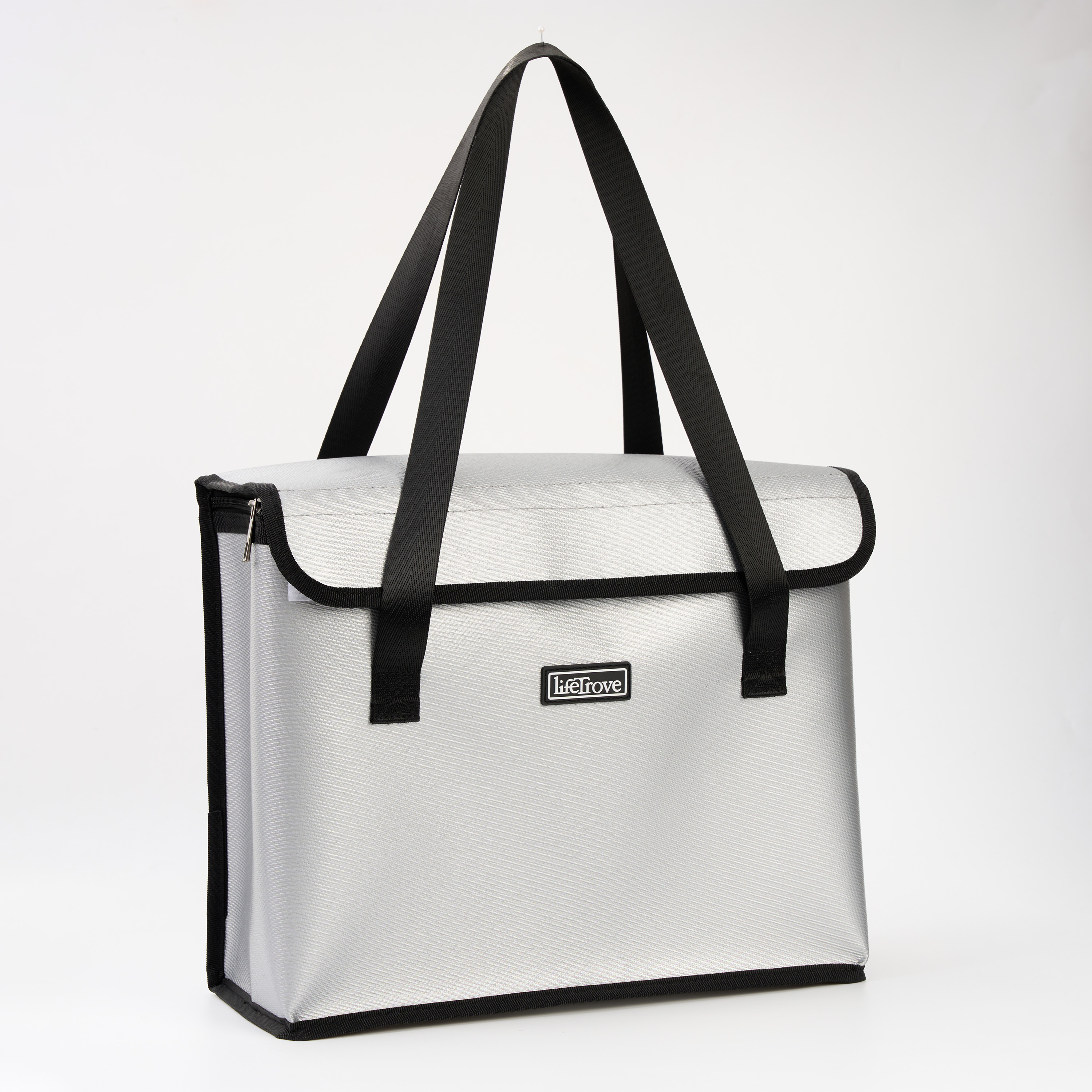 A silver tote bag with black straps and trim, hanging against a plain white background.