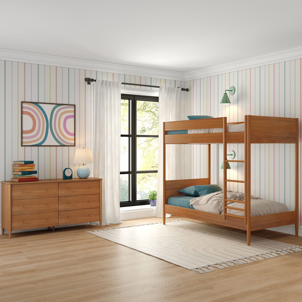 A colorful striped room with a warm-wood bunk bed and matching dresser. There is a large window behind the bed, light fixtures on the wall, and a white rug on the floor. 