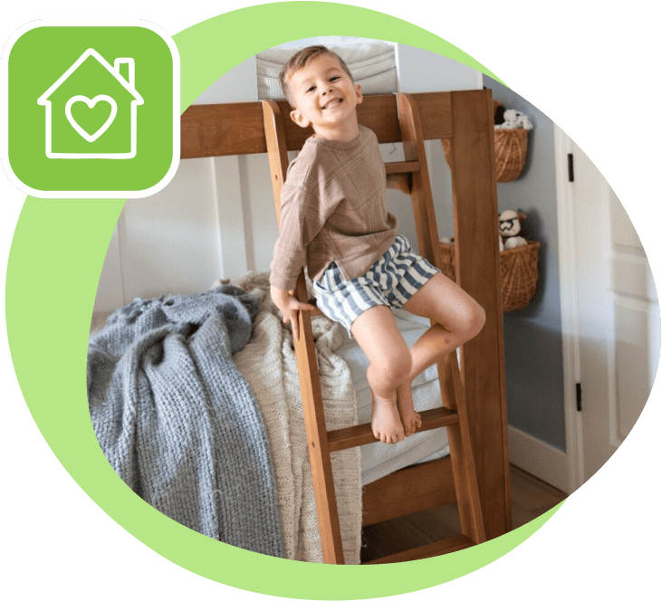 little boy smiling on bunk bed ladder