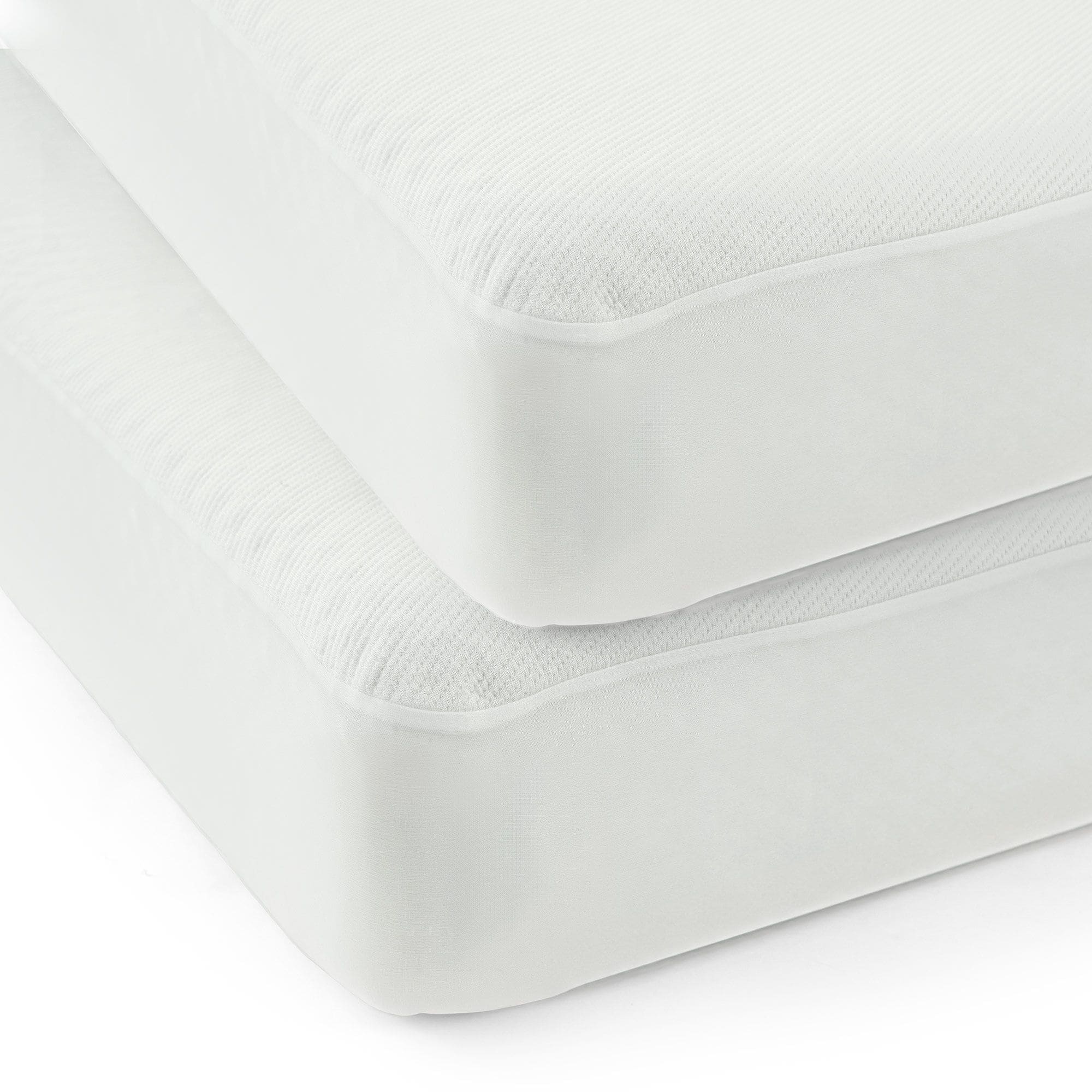 Two stacked white mattresses with textured fabric.
