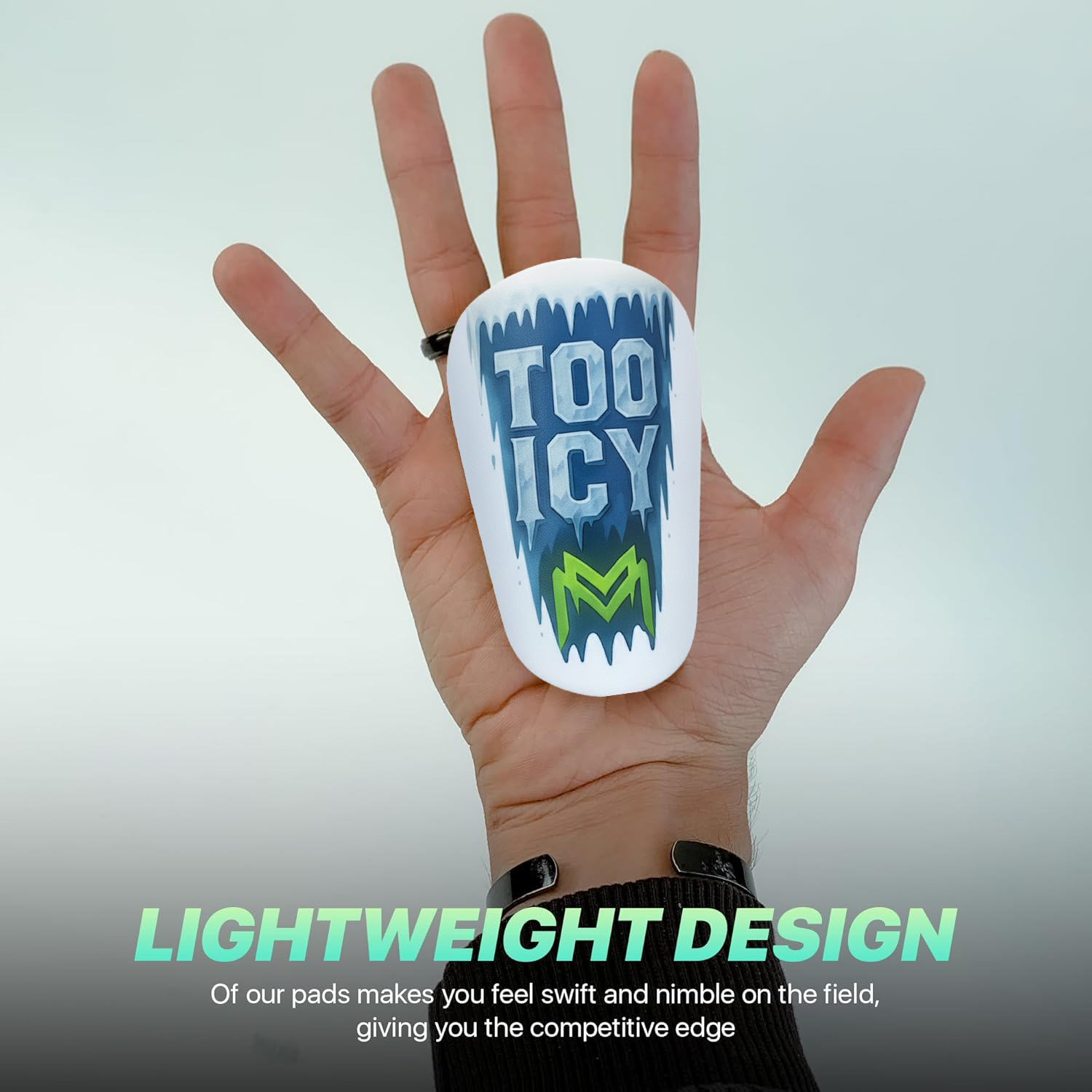 Hand holding shin pad with 'TOO ICY' text.