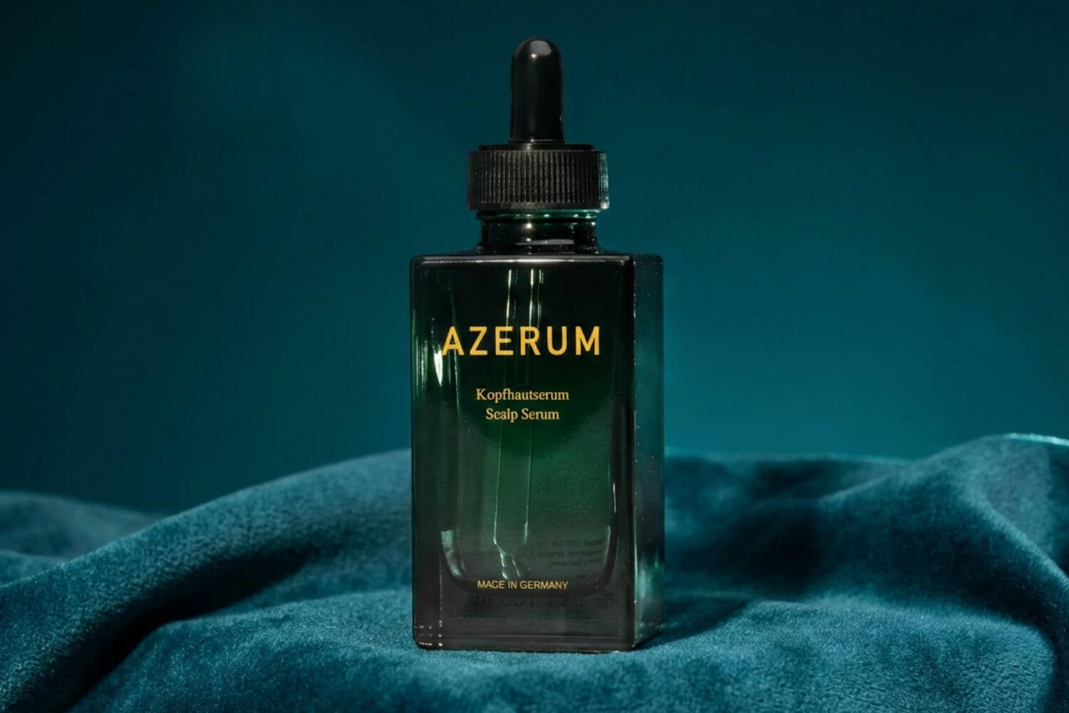 A dark green, square bottle of Azerum Scalp Serum with a black dropper cap against a green background.