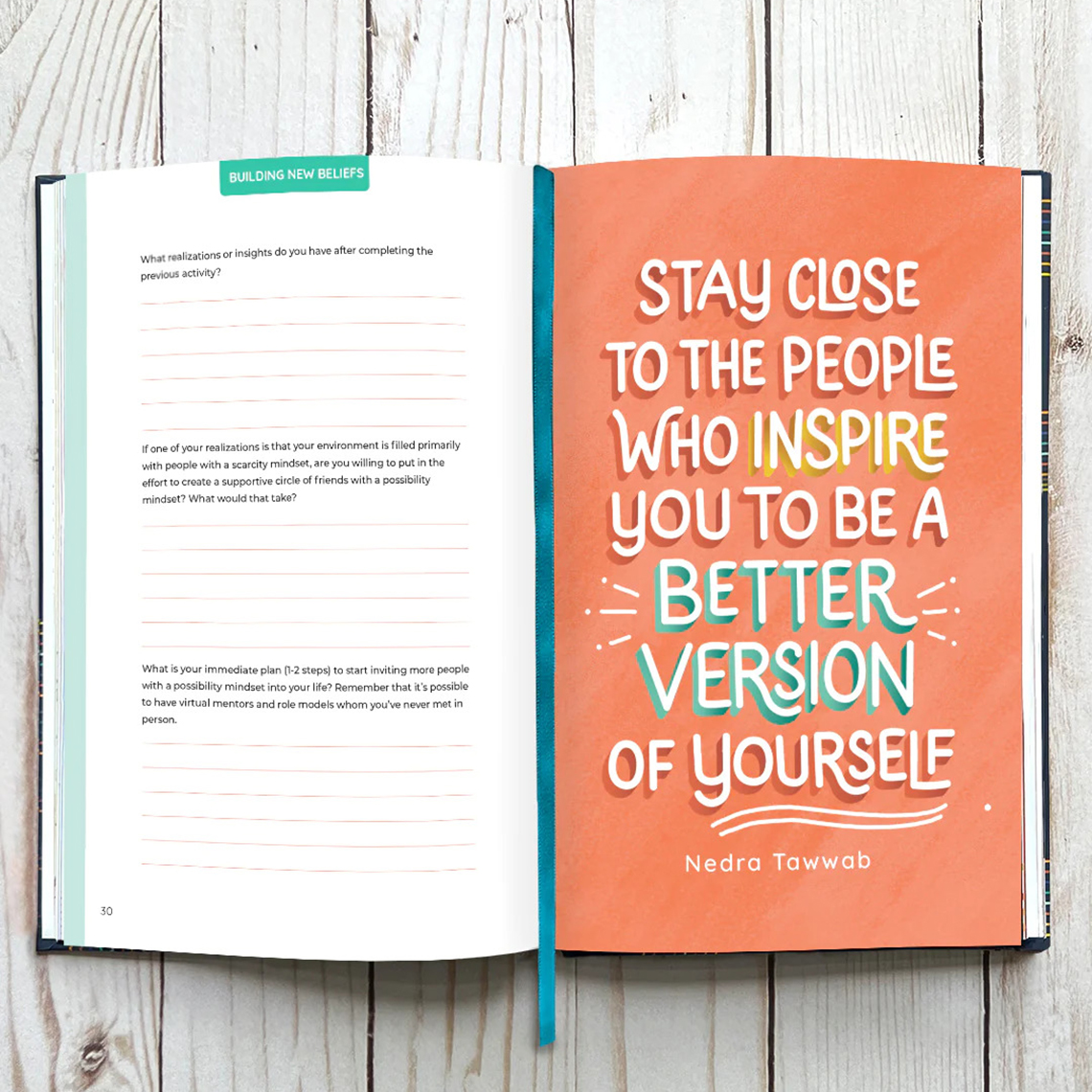 An open journal with writing prompts on one page and an inspirational quote on the other.