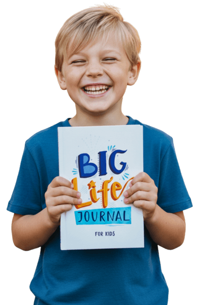 A smiling boy in a blue shirt holds up a book titled 'Big Life Journal for Kids'.