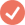 A blurry, low-resolution icon of a white checkmark inside a reddish-orange circle.