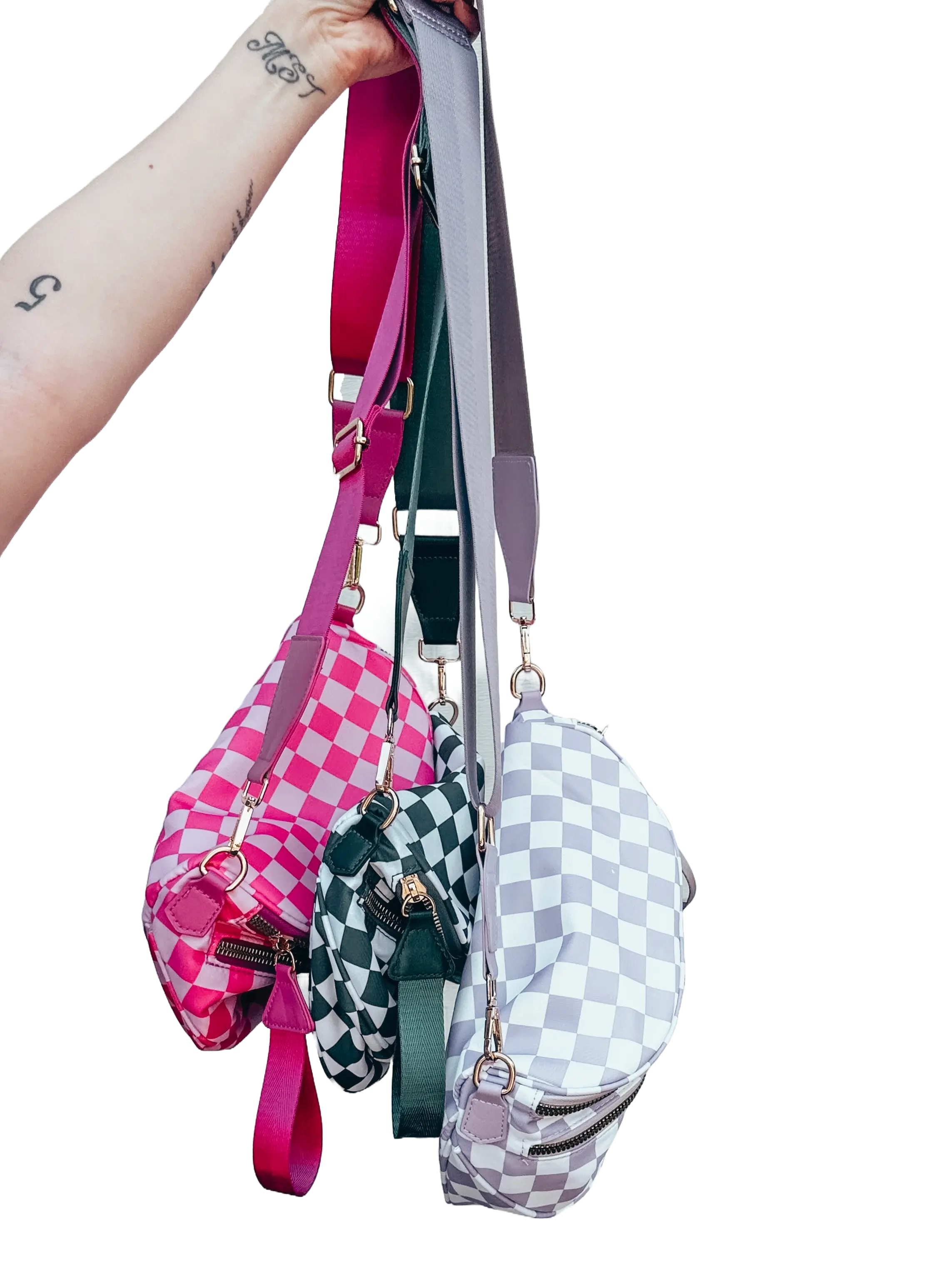 Three checkered bags in pink, green, and gray held in a hand.