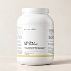 A white tub of Sakara Protein + Metabolism powder supplement against a plain, light-colored background.