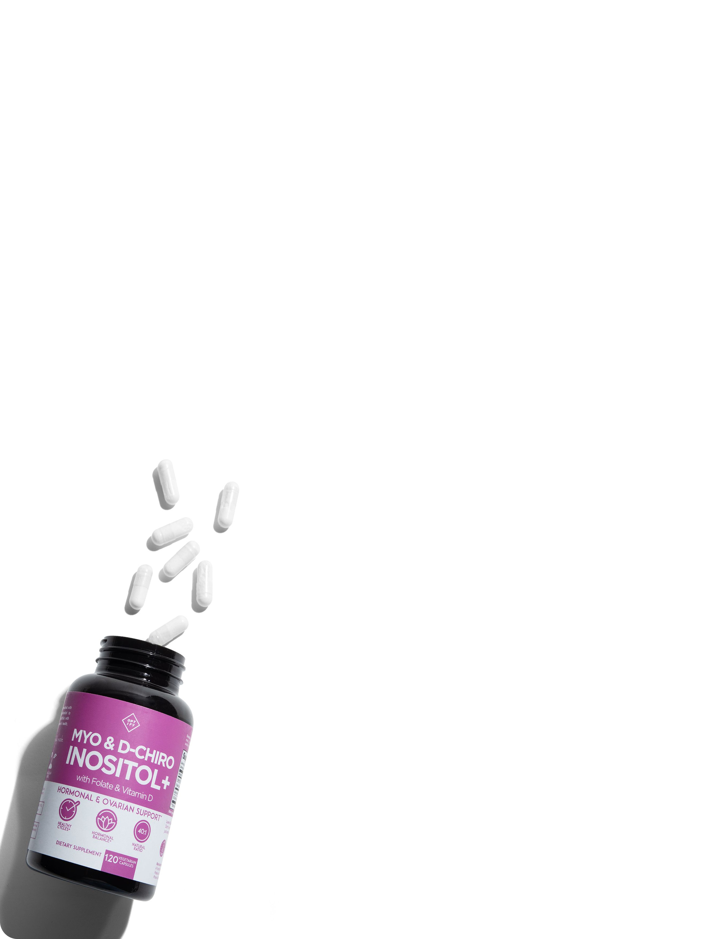 A bottle of Myo & D-Chiro Inositol+ supplements with several white capsules spilling out onto a white surface.