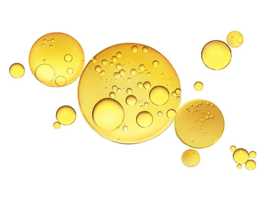 Yellow oil bubbles floating on a white background.