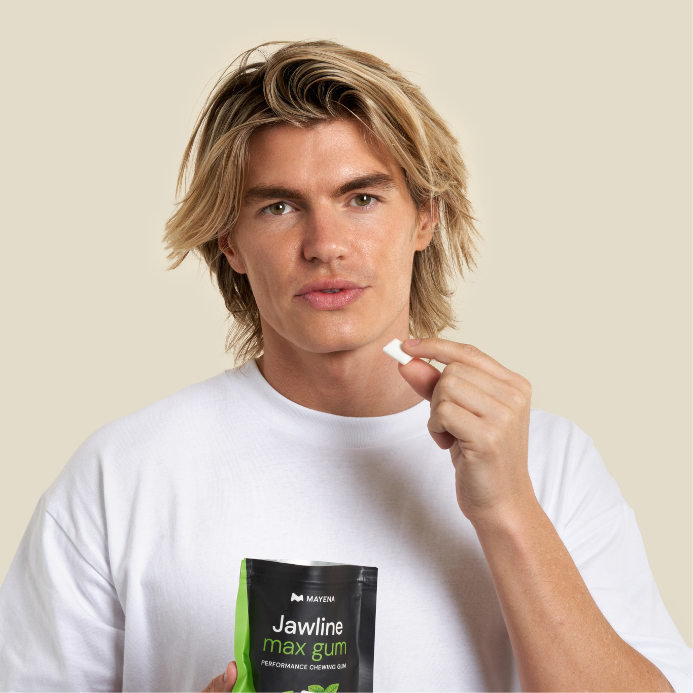 Man holding a pack of Mayena Jawline Max Gum and one piece