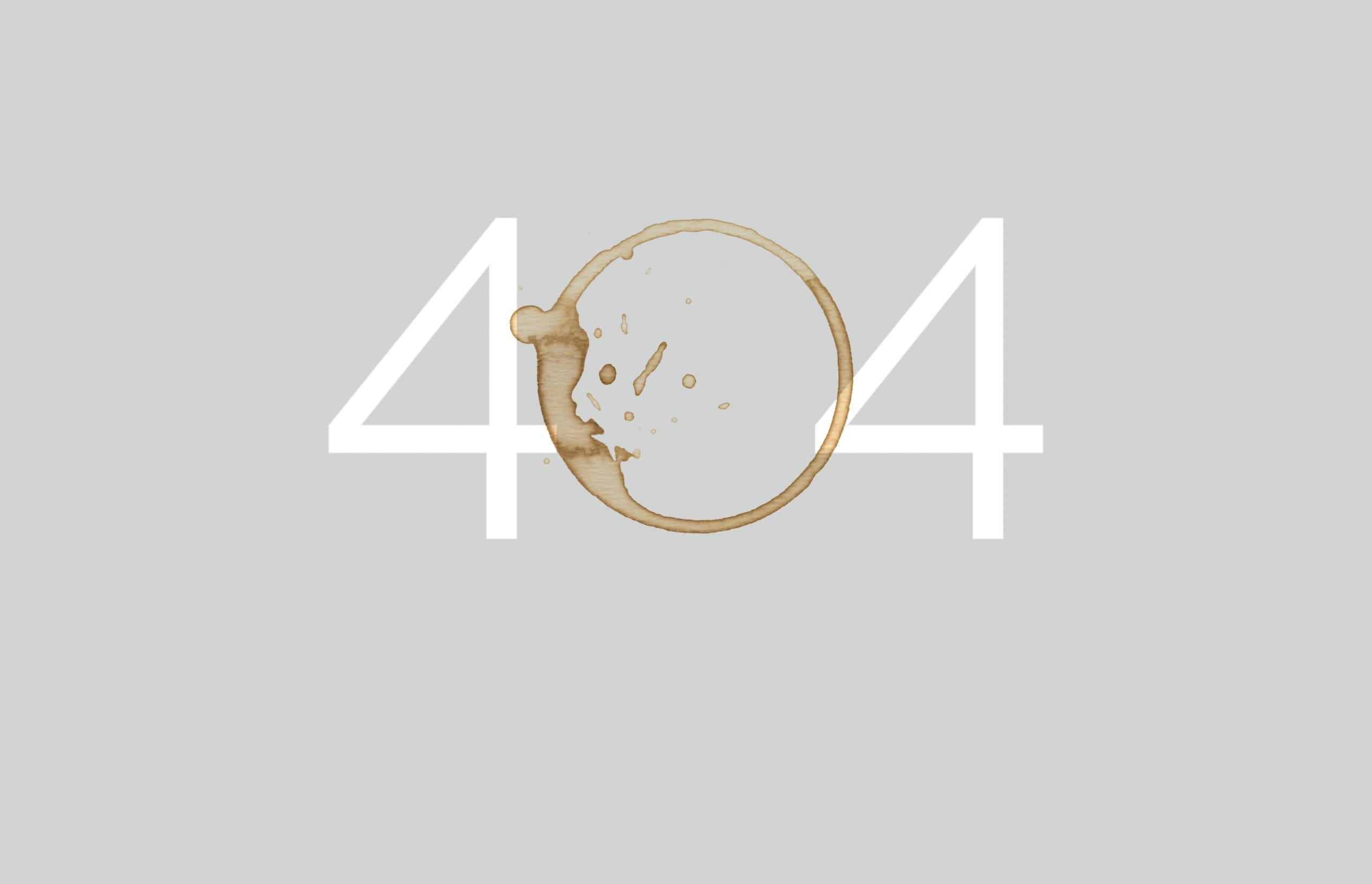 '404 error with coffee stain on gray background.'