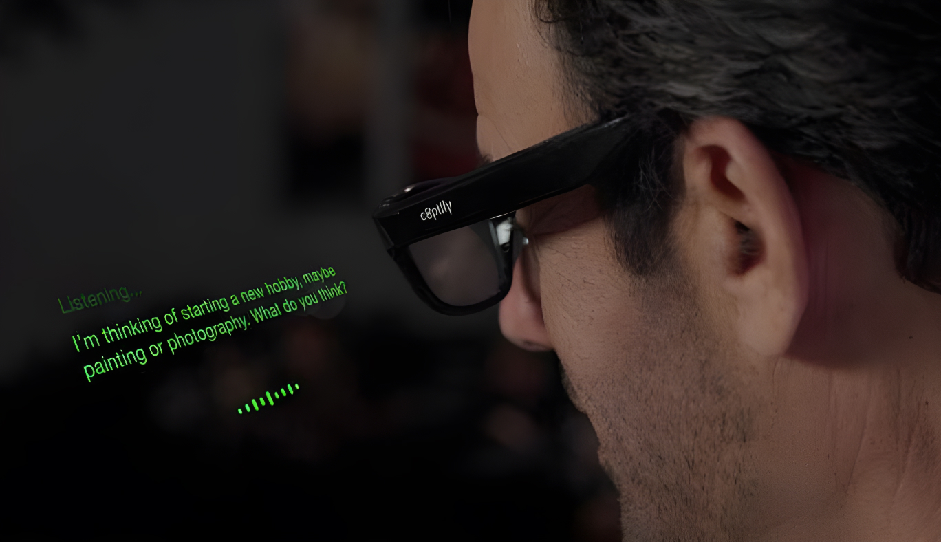 Man wearing smart glasses with green text display.