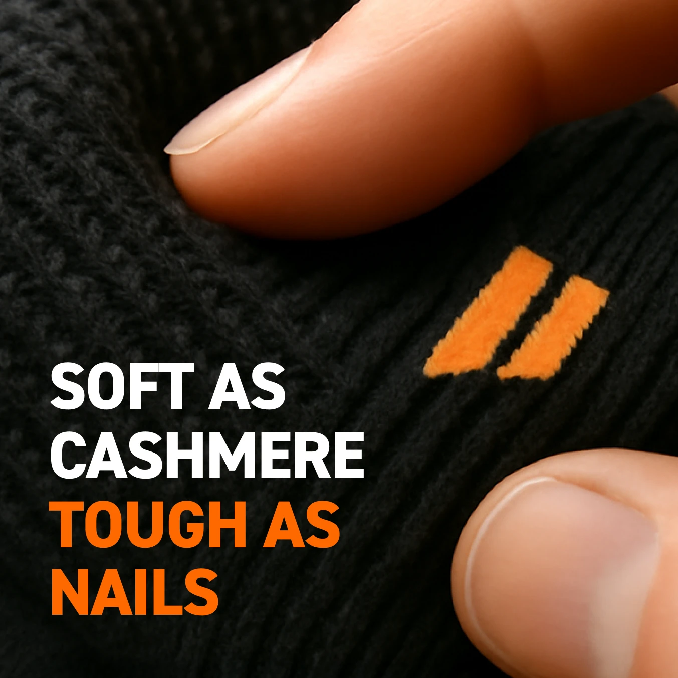 Fingers touching black fabric with orange stripes and text: 'Soft as cashmere, tough as nails'.