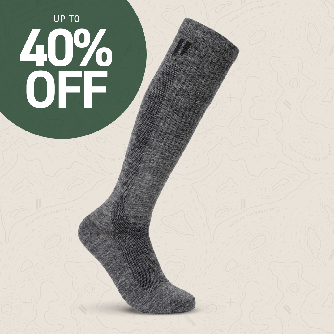 Gray knee-high sock with a 40% off discount label on a patterned background.