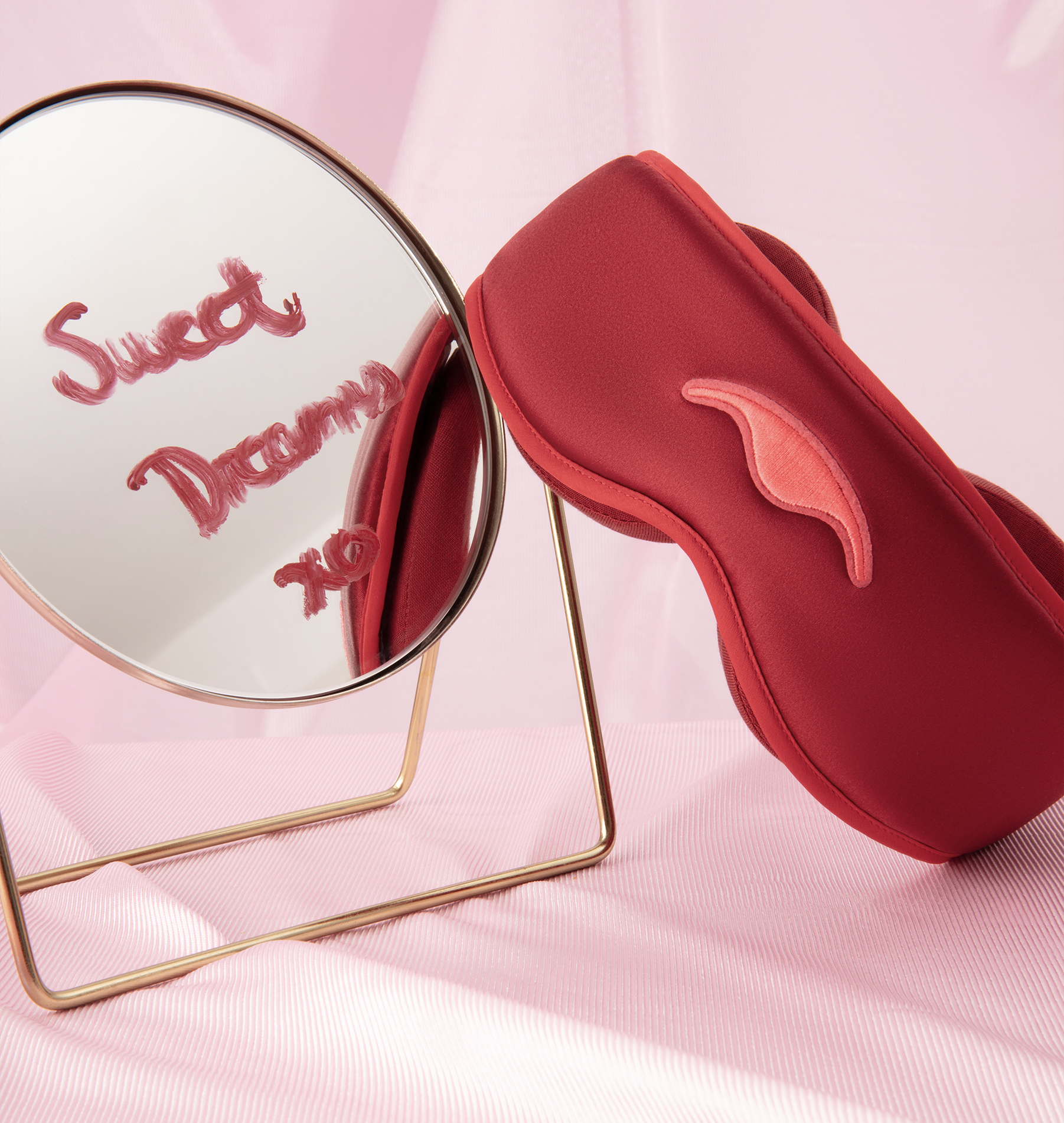 Red eye mask and mirror with 'Sweet Dreams xo' written on it.