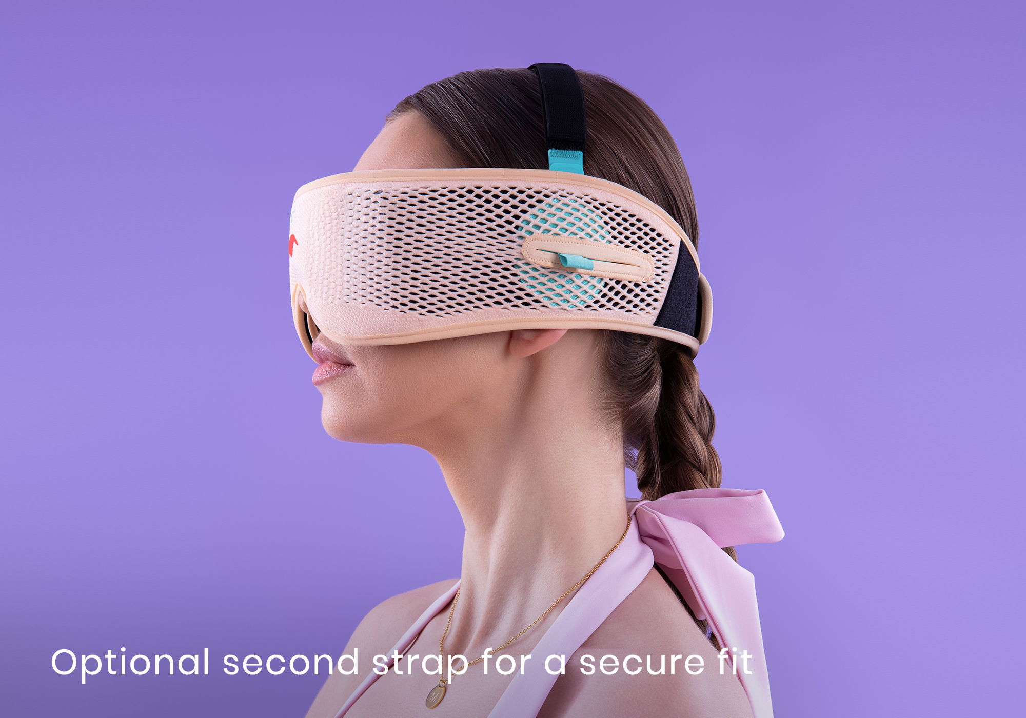 Person wearing a beige mesh eye mask with black strap on purple background.