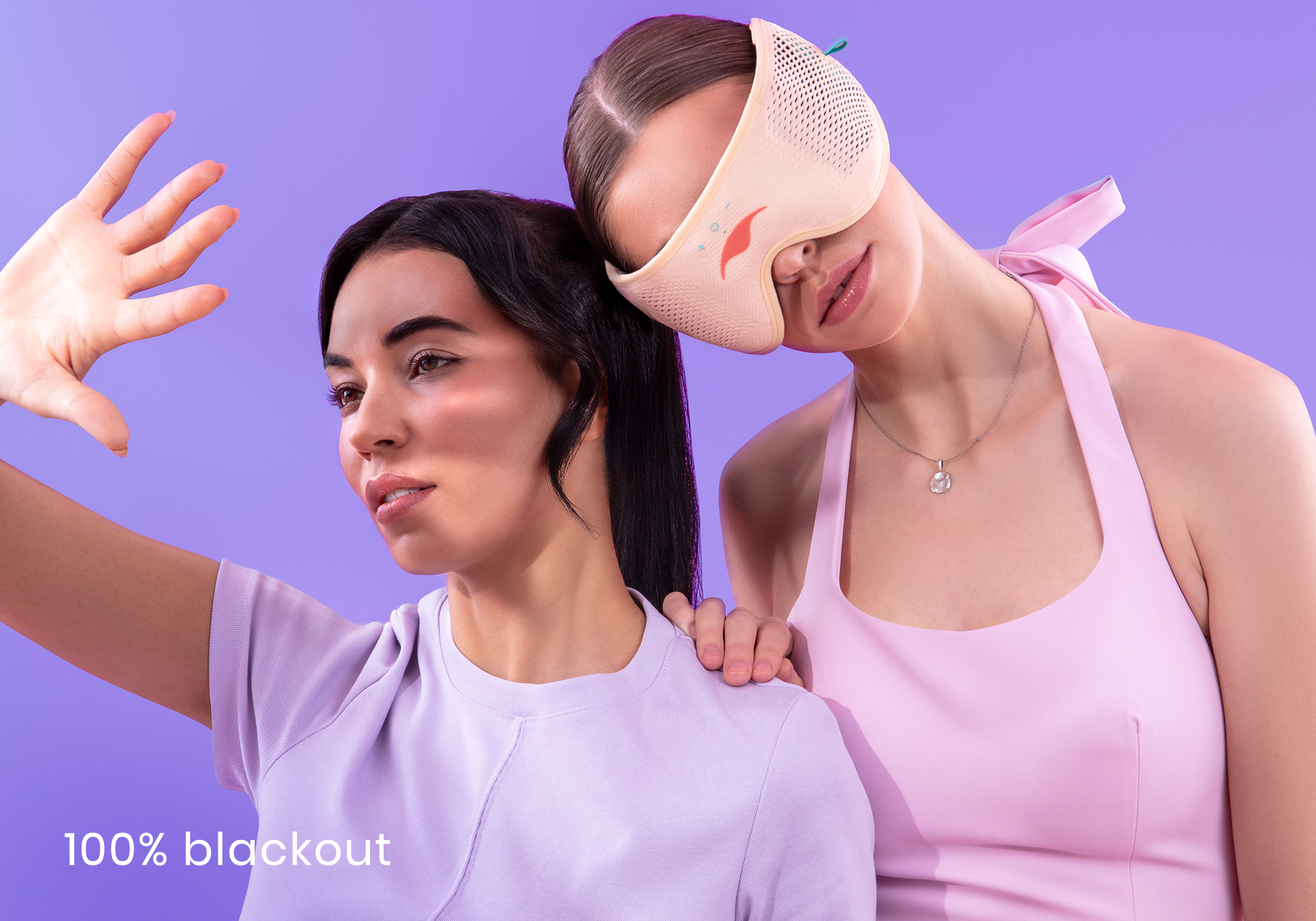 Two women in pastel clothing; one wearing an eye mask.