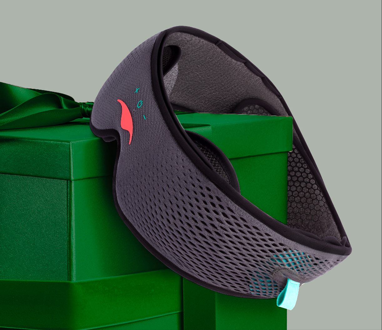 Gray mesh mask on a green gift box with a ribbon.