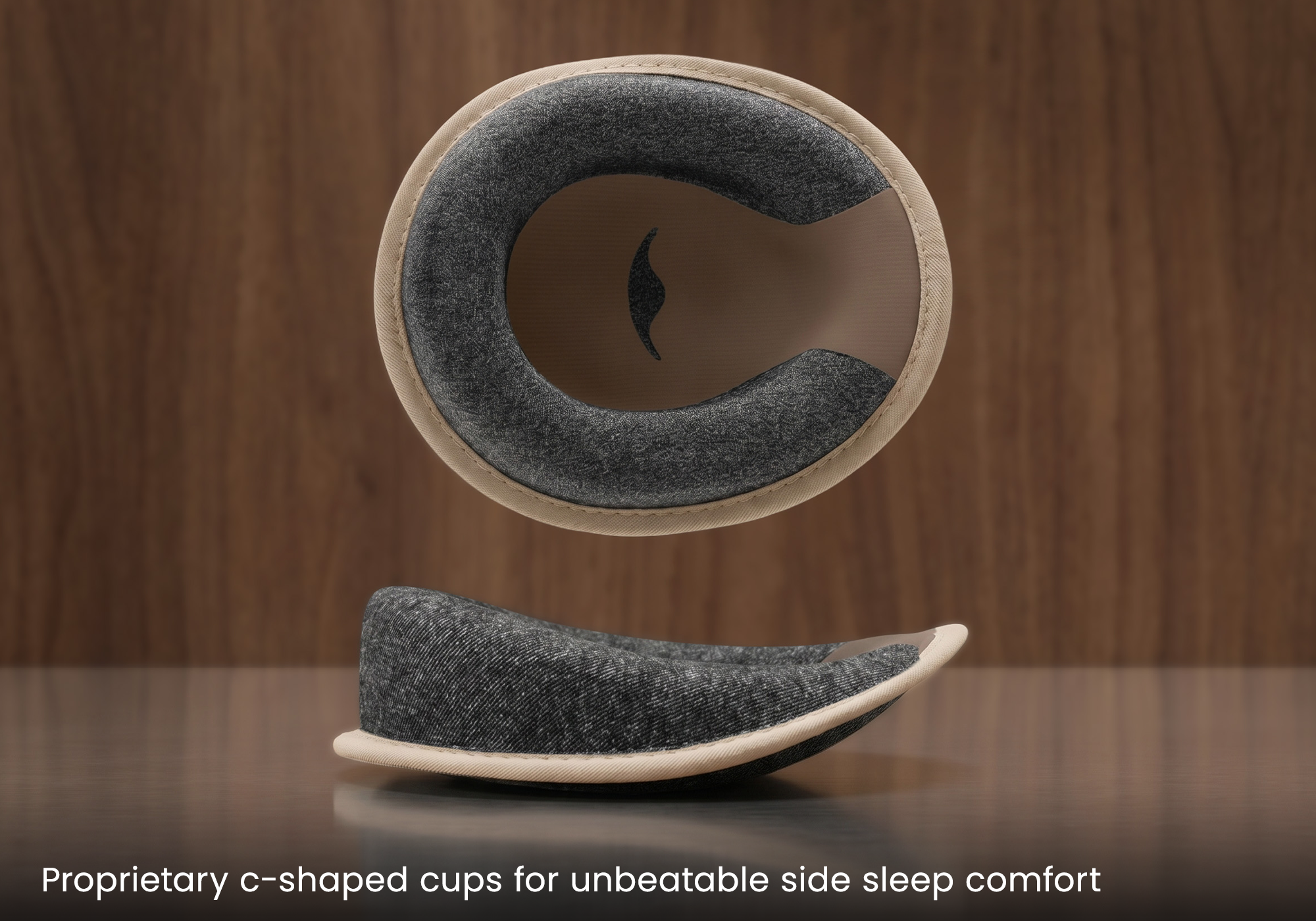 Two views of a padded, c-shaped cup for side sleeping against a wooden background.