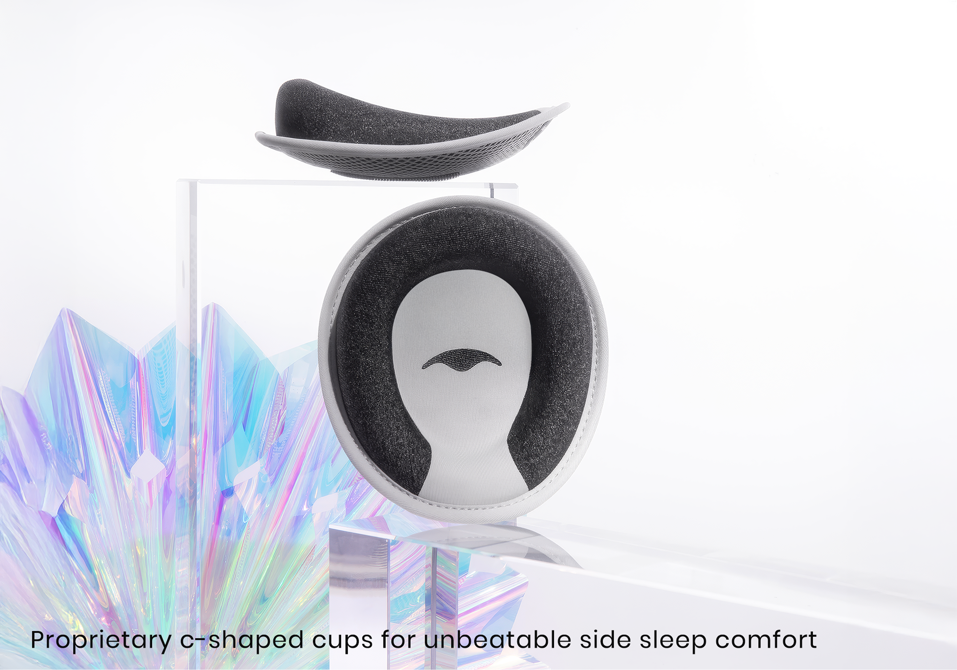 Two C-shaped padded cups, likely for a sleep mask, are displayed on clear acrylic stands.