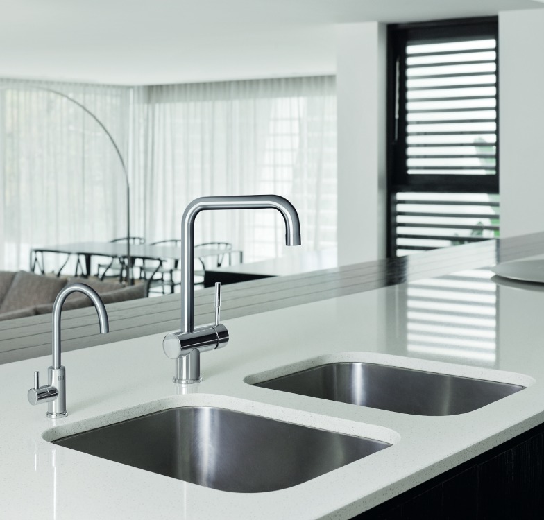 Modern kitchen with double sink and chrome faucets.