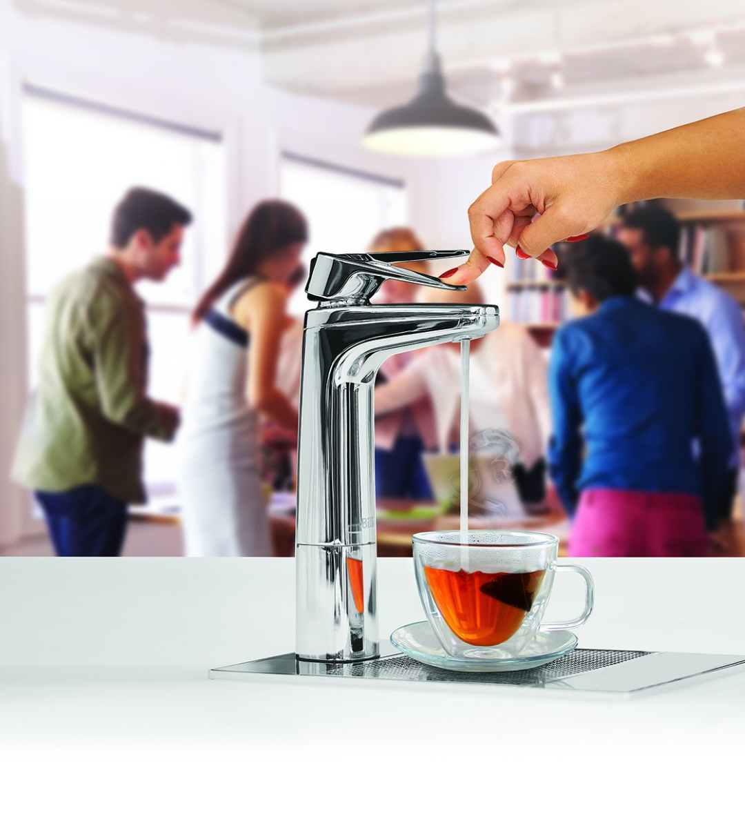 A hand operating a modern faucet pouring water into a glass cup with tea.